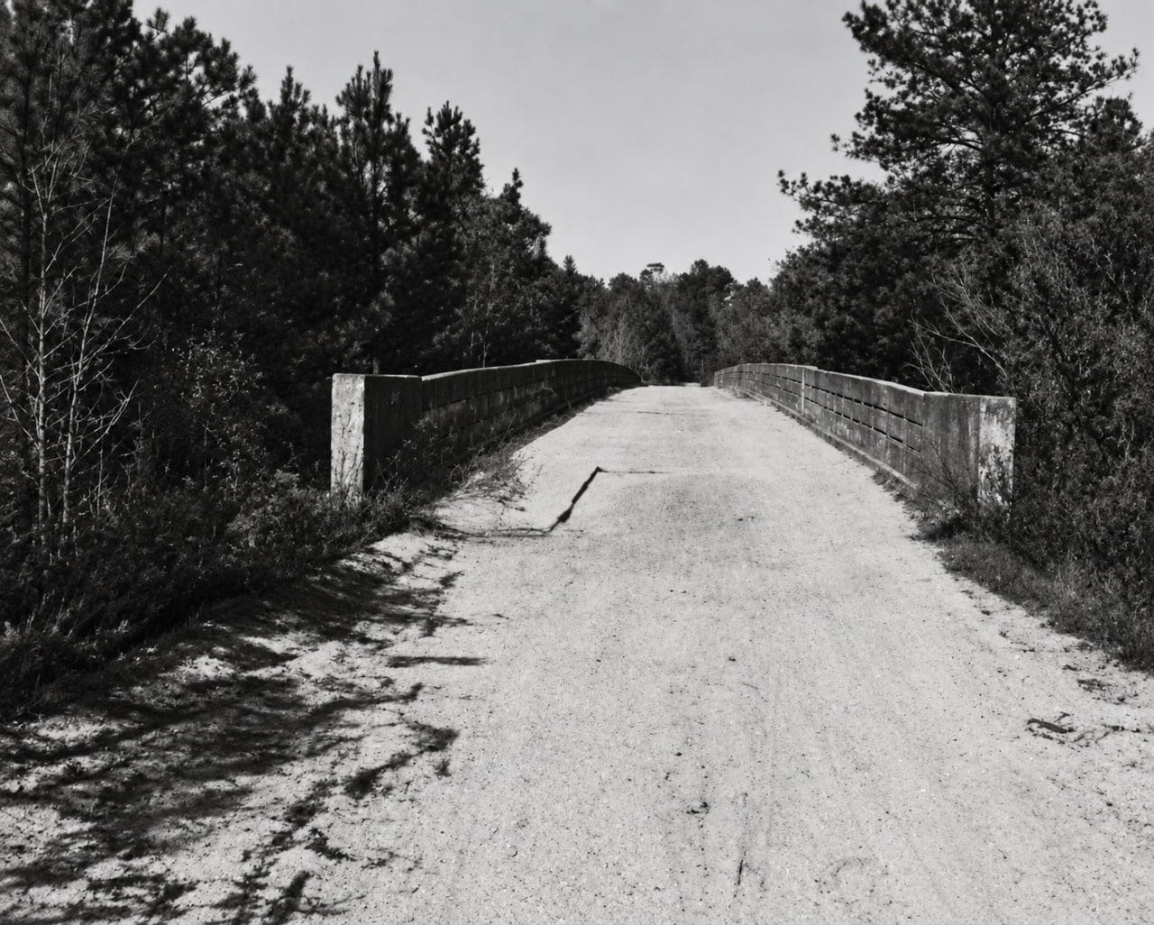 AI-restored circa-1950 photograph looking across the top of the old Rock Bridge over Little River